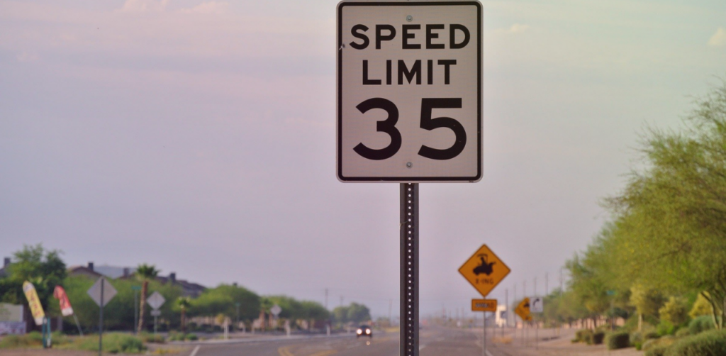 Speed limit sign displays a maximum speed of 35 mph along a suburban road
