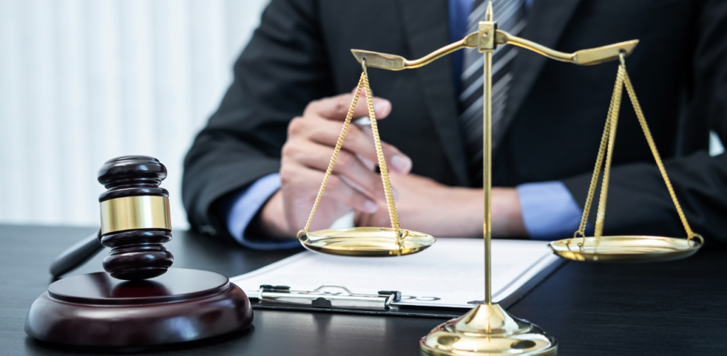 Personal injury attorney reviewing case file with scales of justice