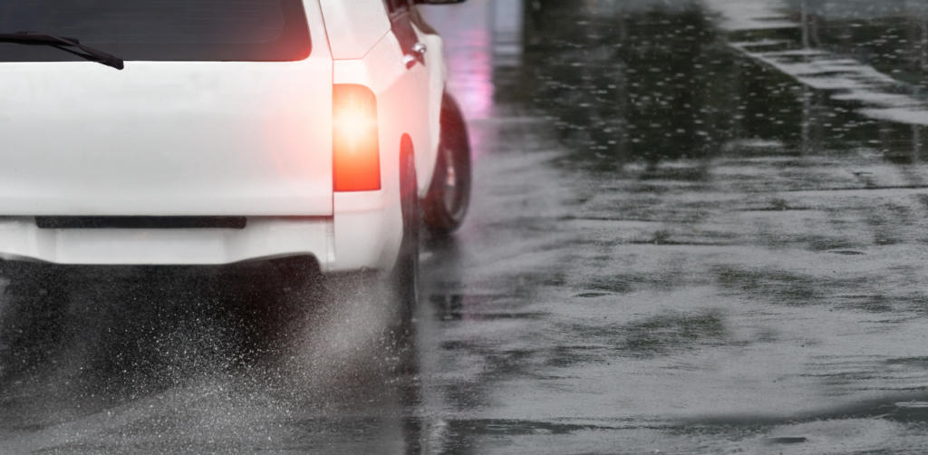 Vehicle driving on wet road in rain with reduced visibility, relevant to Casino Escalator Accident Claims safety context