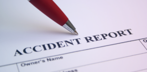 Pen resting on an accident report form ready to be completed
